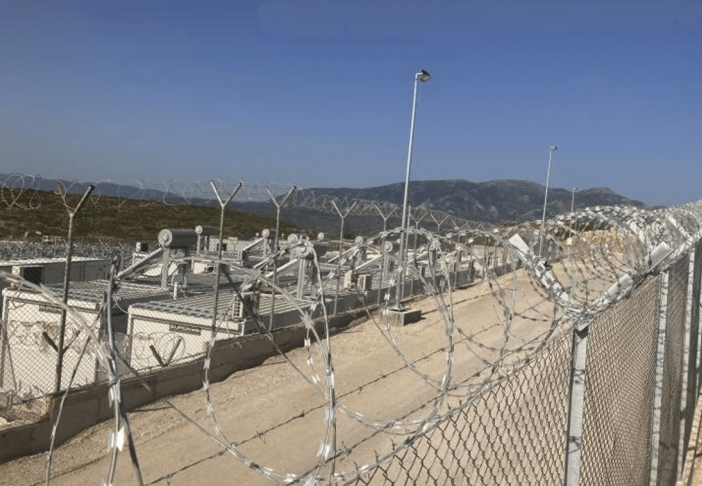 Two security fences with barbed wire and a patrol perimeter around the closed and controlled refugee detention centre in Samos. Photo by Petra Molnar.