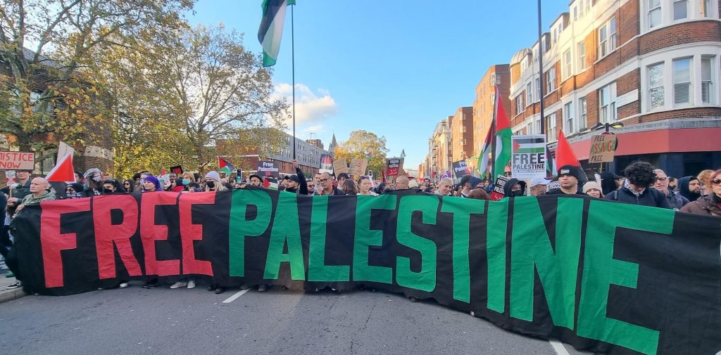 Photo of a demonstration holding a massive Free Palestine sign